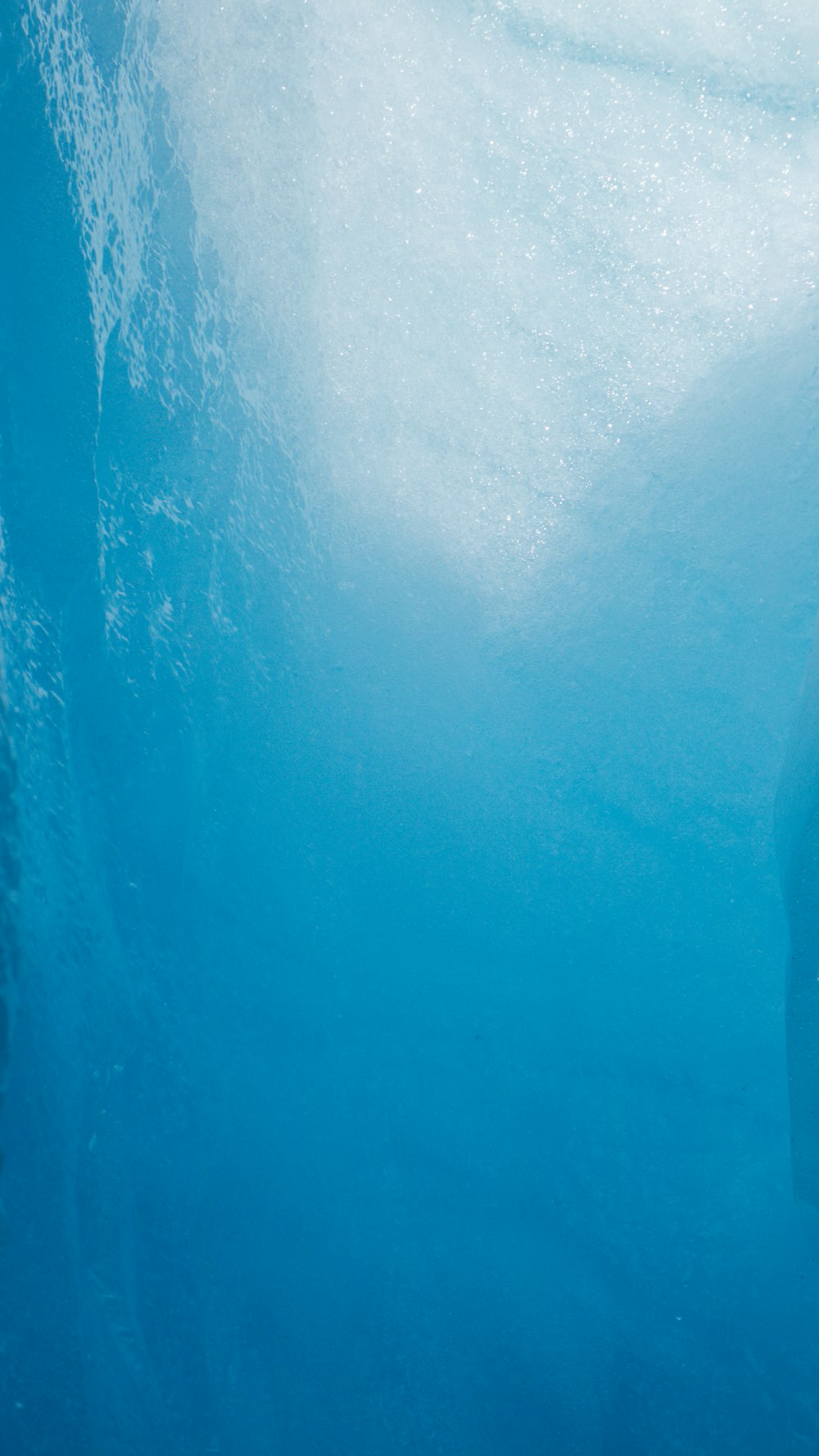 a man in a wet suit swimming under water