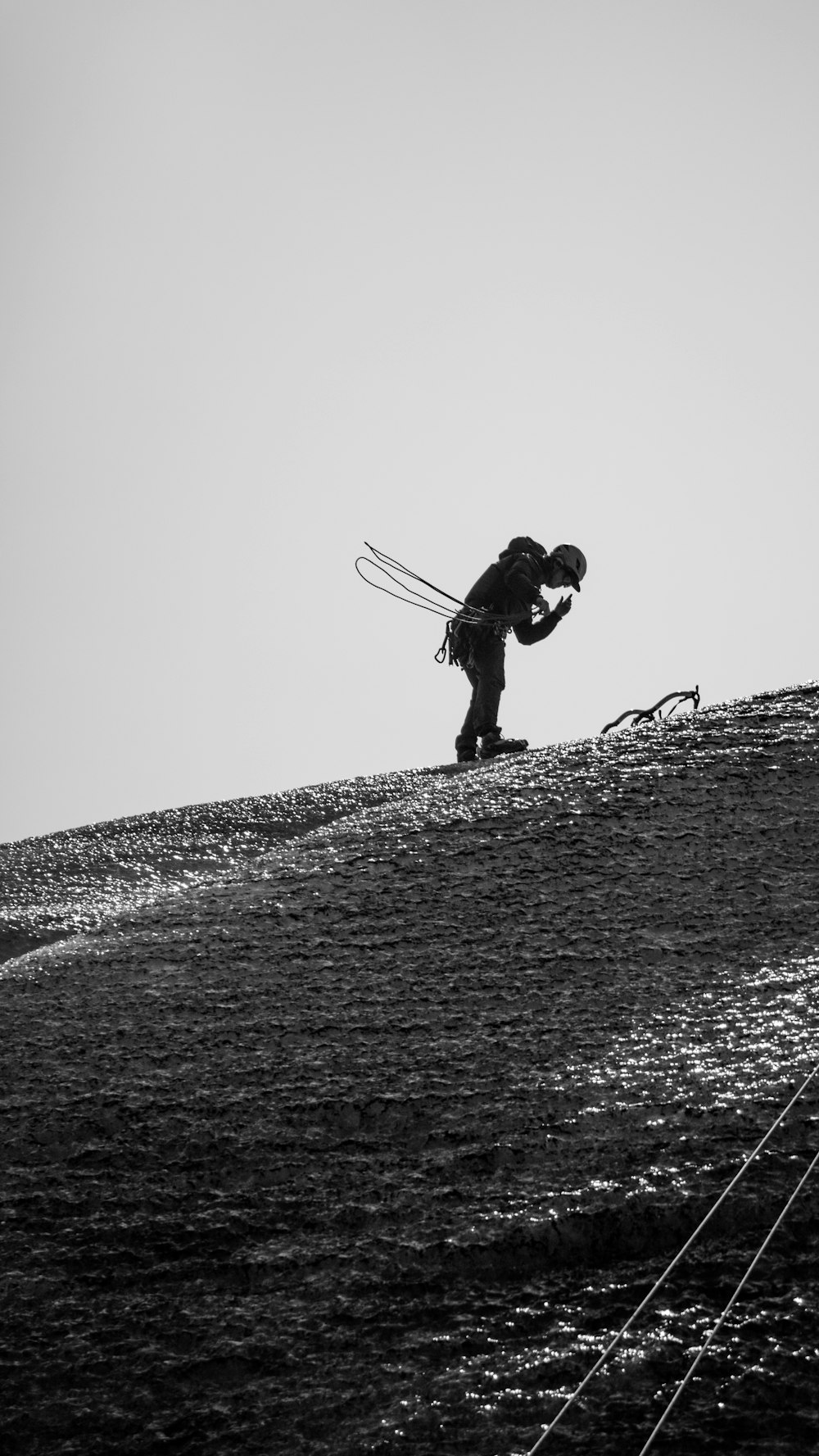 uma foto em preto e branco de uma pessoa em uma colina