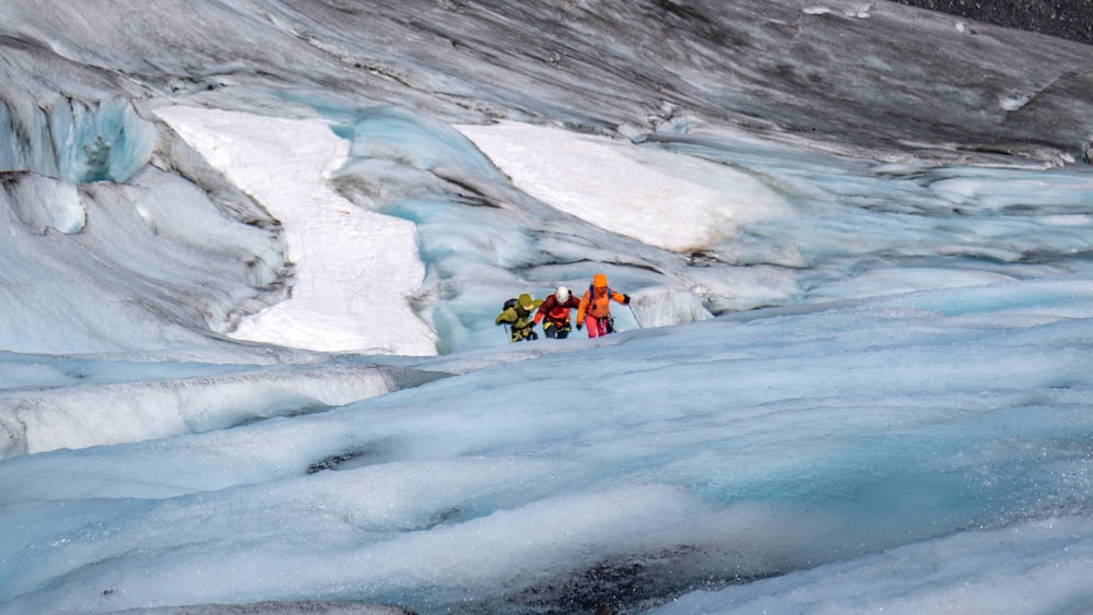 a group of people standing on top of a glacier