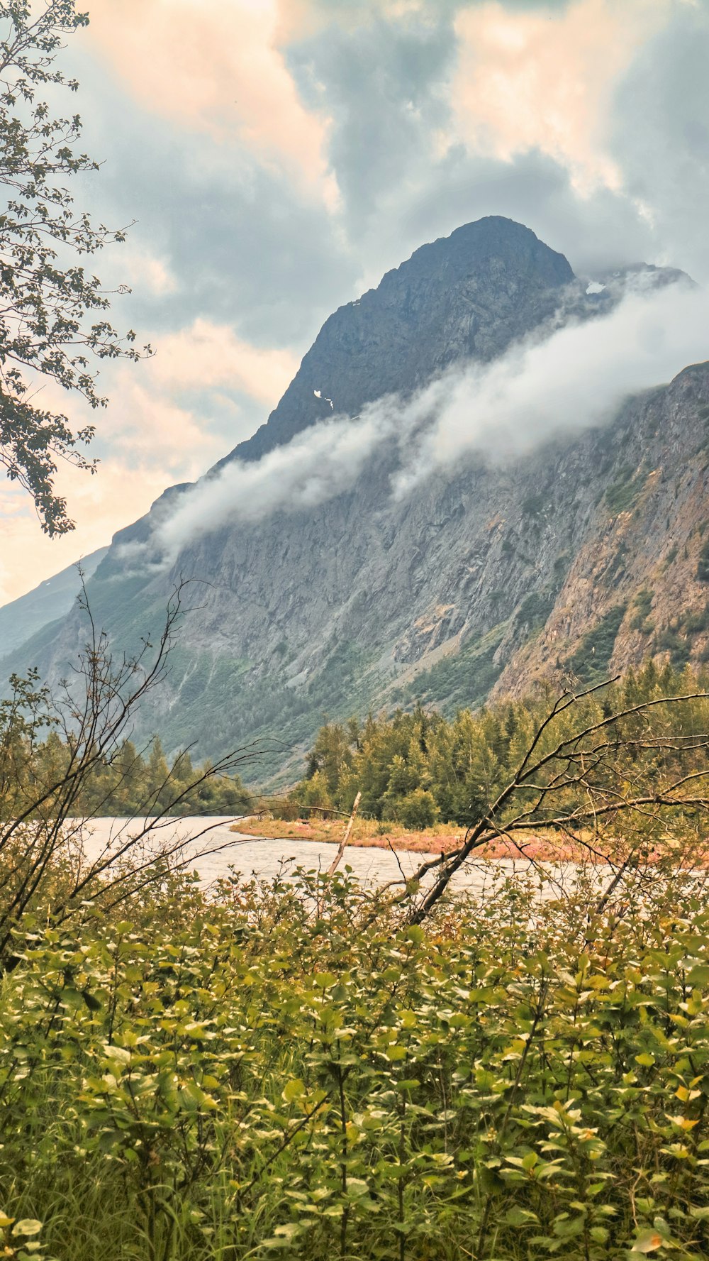 a view of a mountain range with a river in the foreground