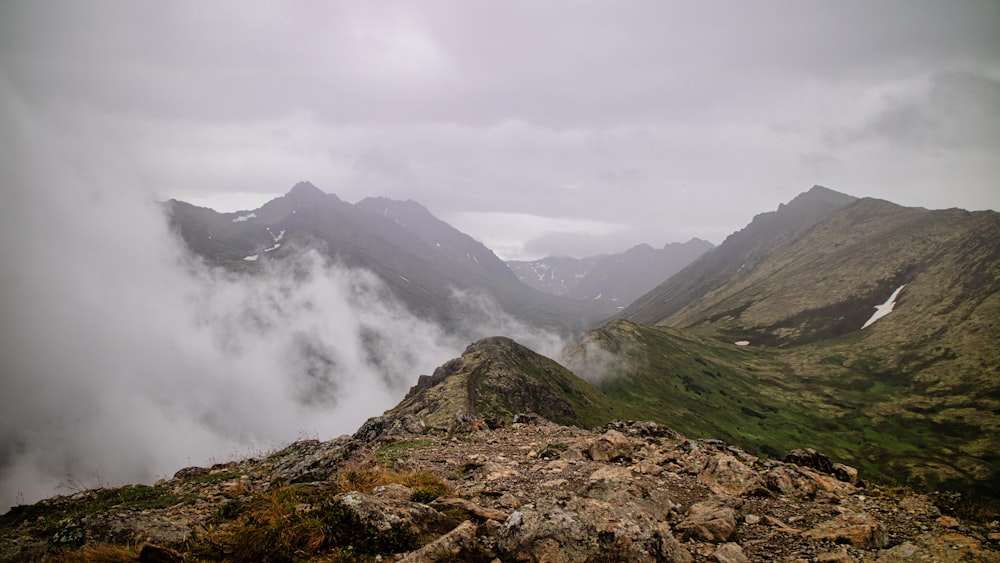 a view of a mountain range with low lying clouds