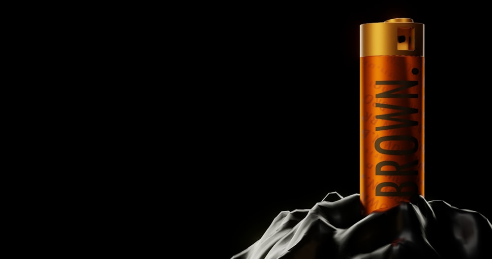 a close up of an orange tube on a black background