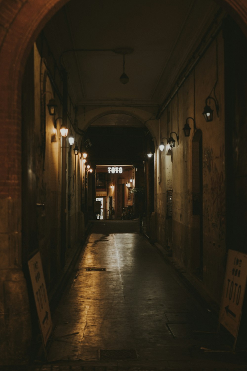 a dimly lit hallway with a sign on the wall