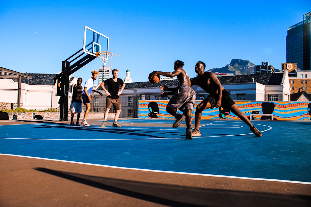 a group of young men playing a game of basketball