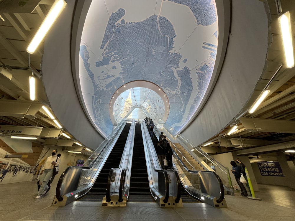 an escalator with a map of the world on it