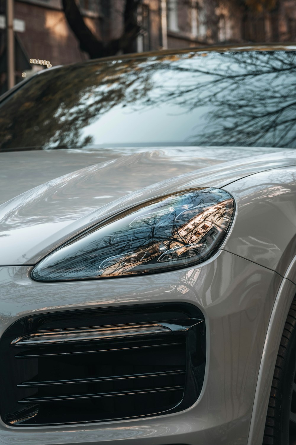 a close up of a silver porsche cayen