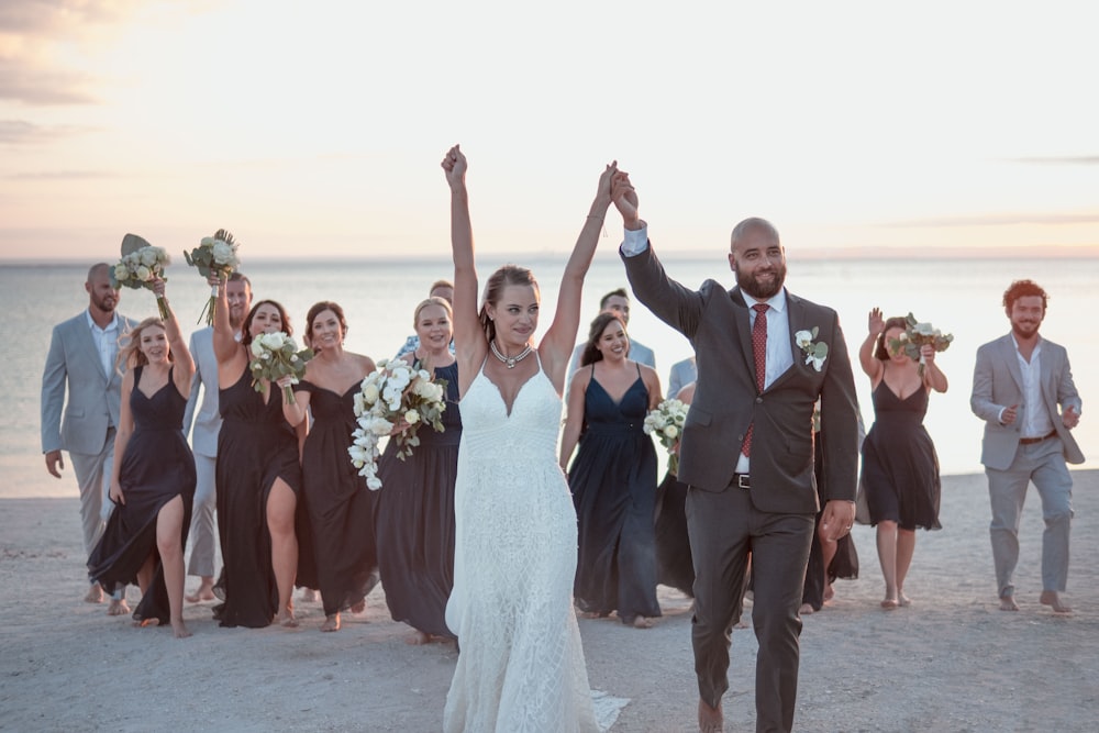 a group of people standing on top of a beach