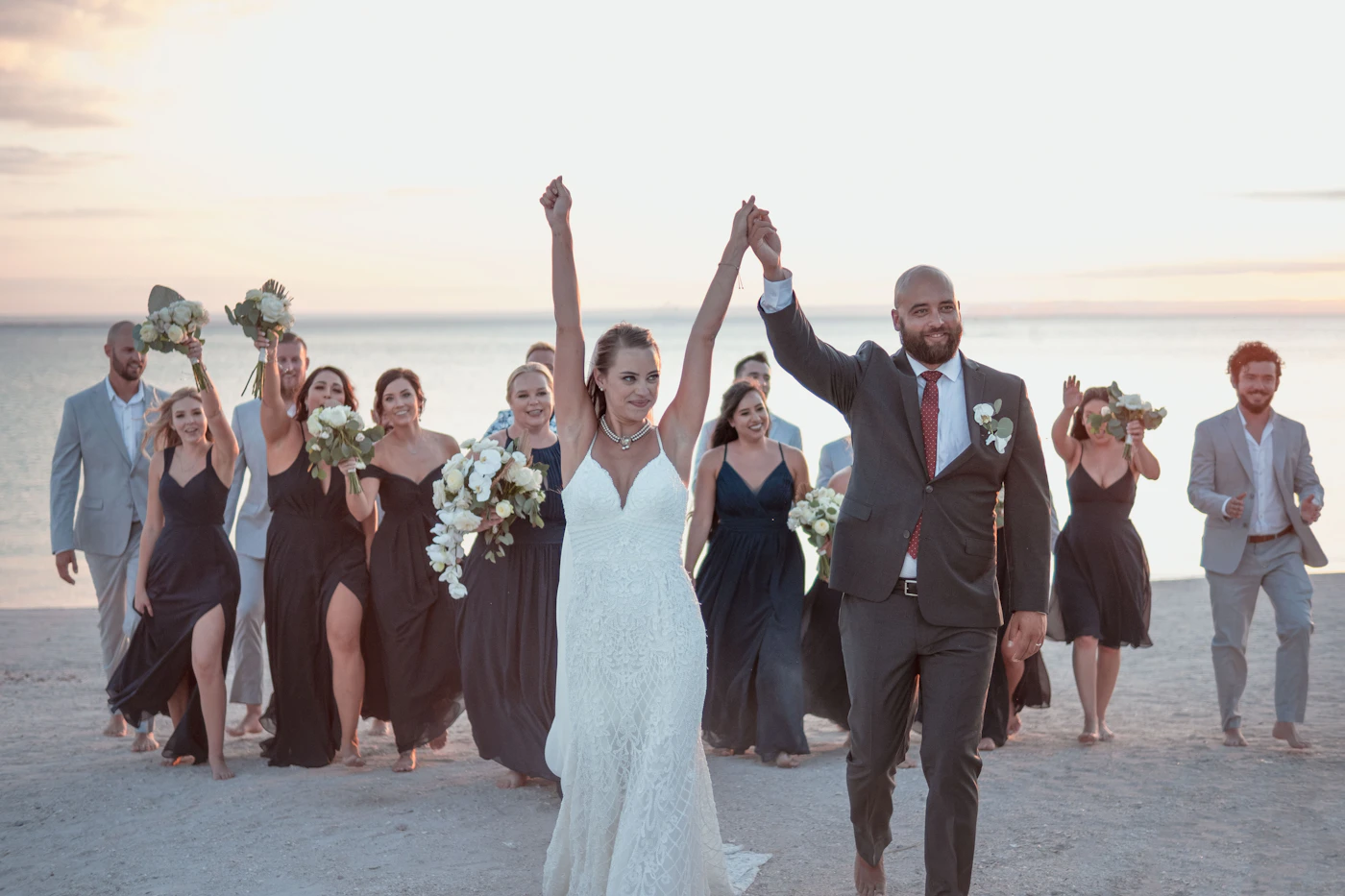 Couple on a Galápagos beach during their elopement with the unique volcanic and tropical ecosystem surrounding them