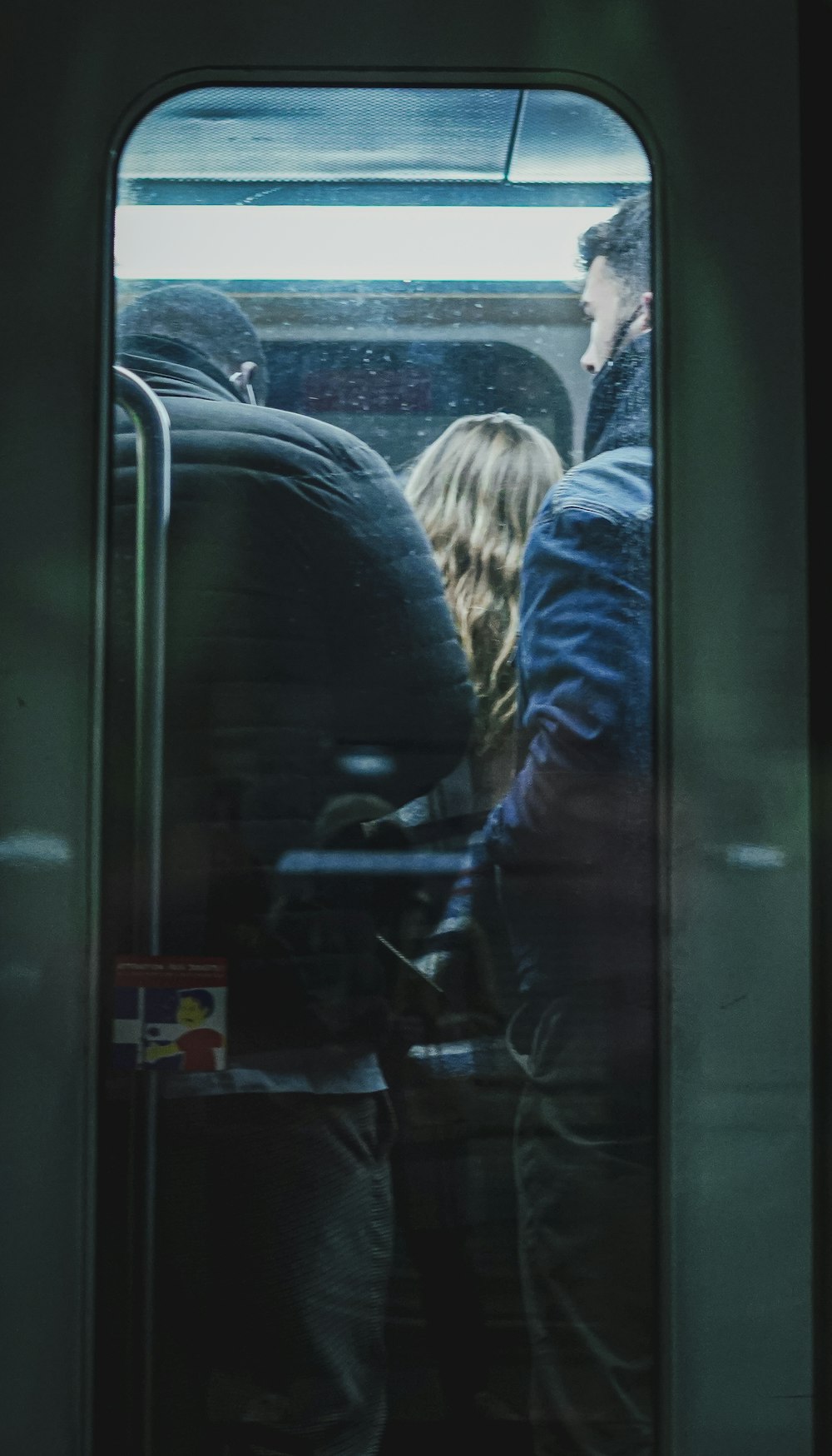 a group of people sitting on a train next to each other