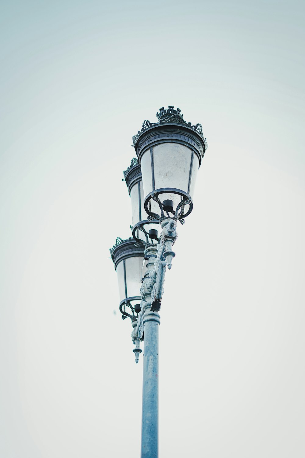 a street light on a pole with a sky background