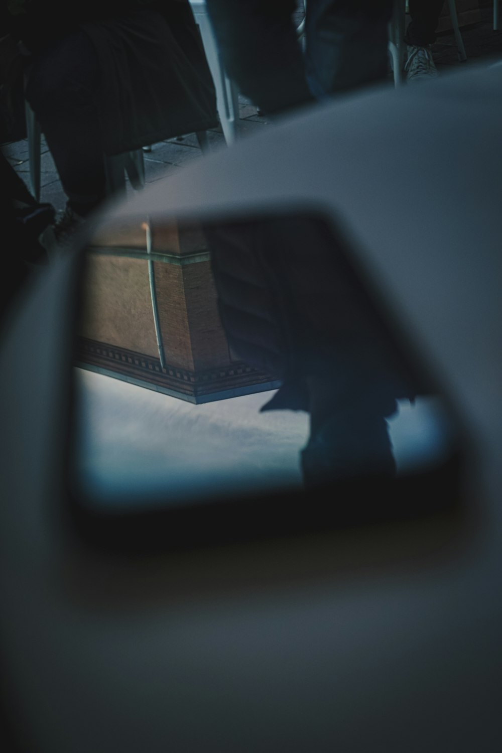 a reflection of a suitcase in a rear view mirror