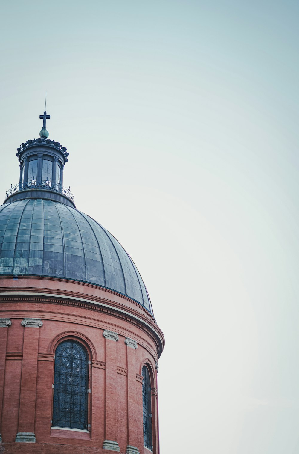 a building with a dome and a cross on top