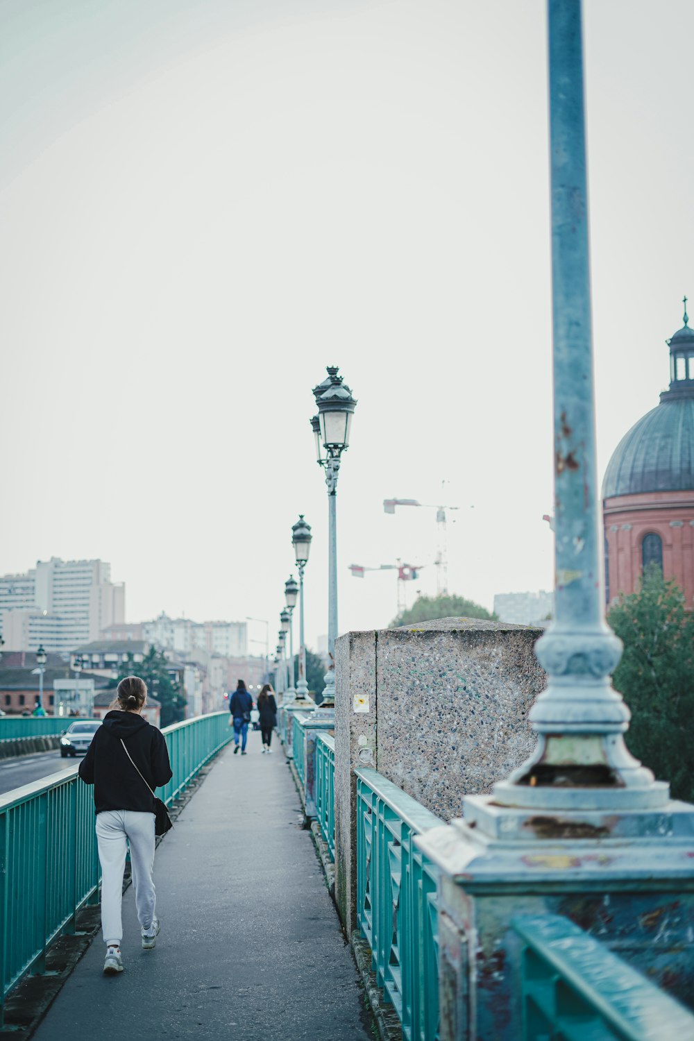 a person walking on a bridge over a river