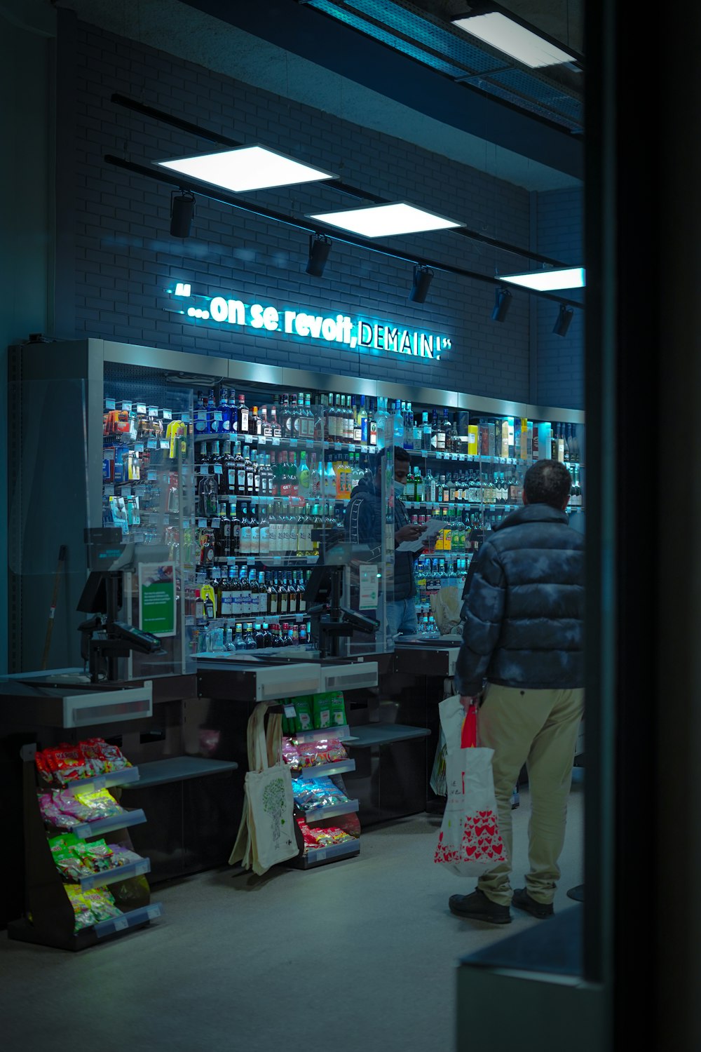 a man standing in front of a store filled with items