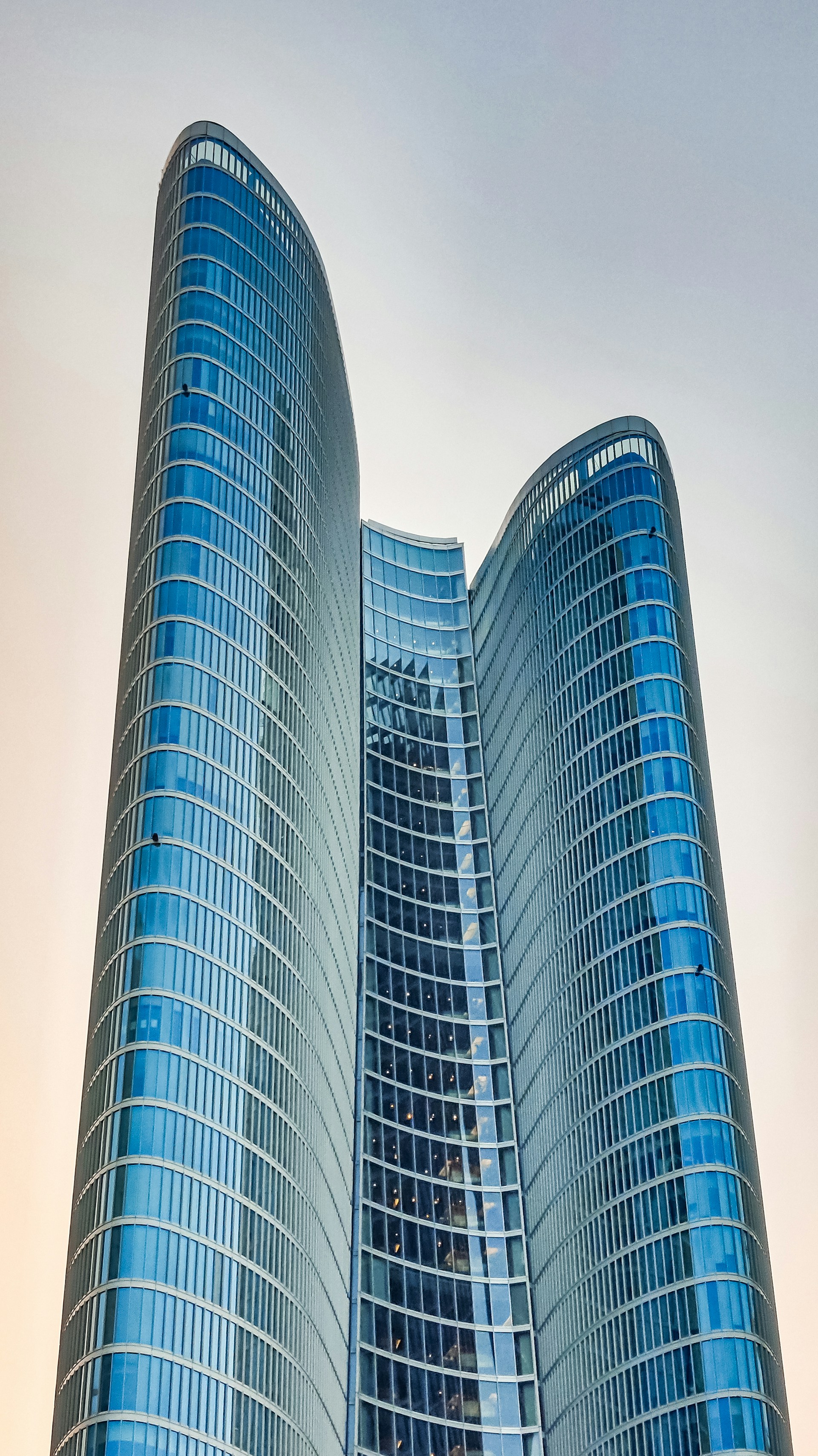 two very tall buildings with a sky background