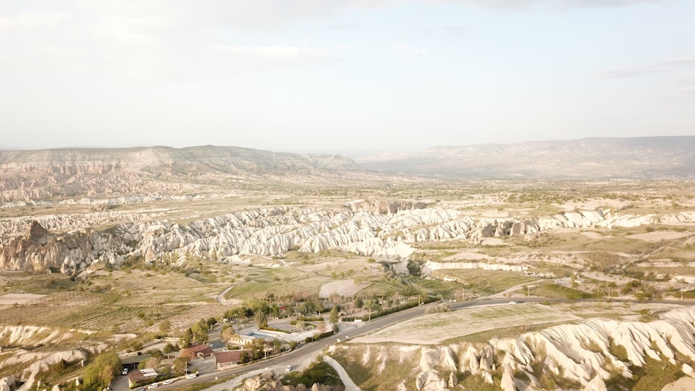 an aerial view of a mountain valley with a road running through it