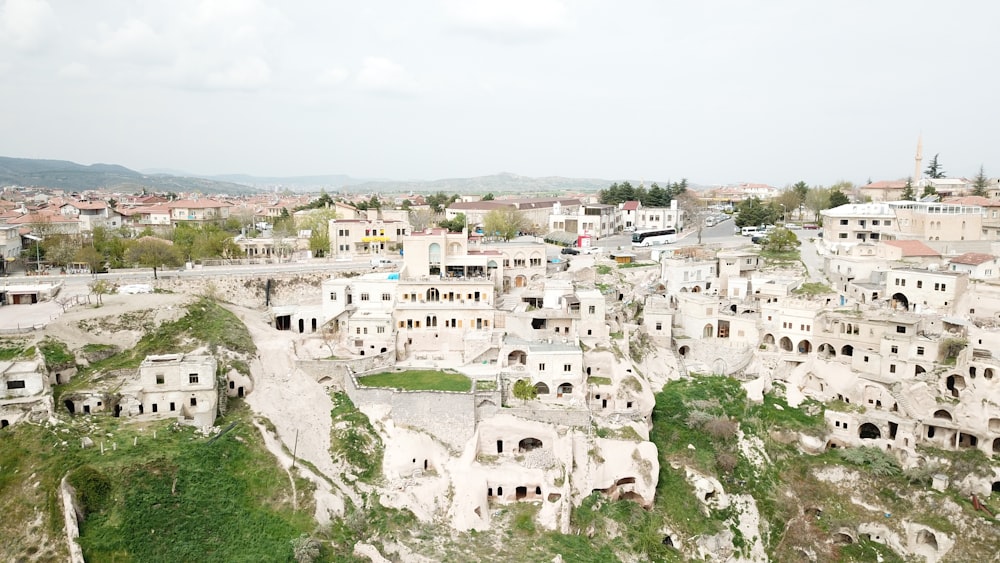 an aerial view of a city with buildings on a cliff