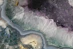 an aerial view of a river running through a forest