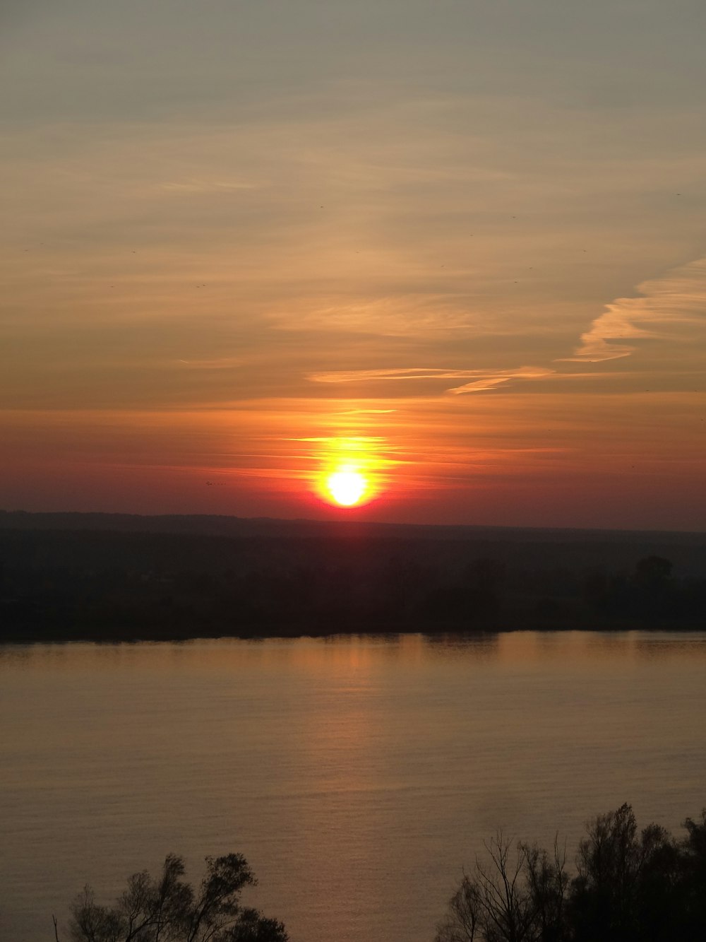 the sun is setting over a body of water