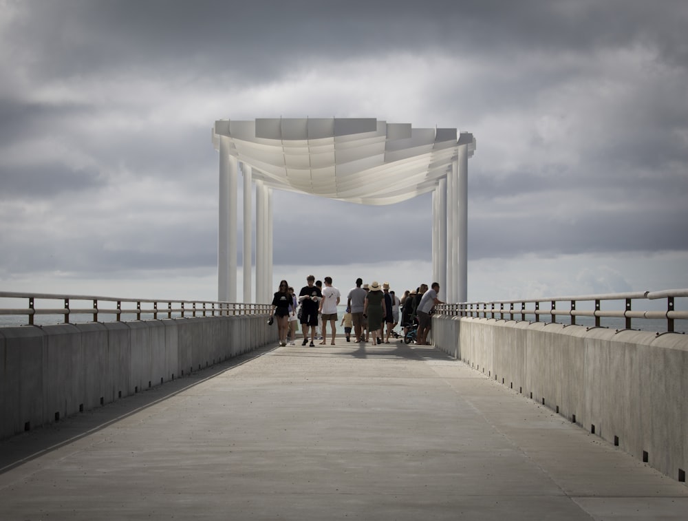 um grupo de pessoas caminhando através de uma ponte