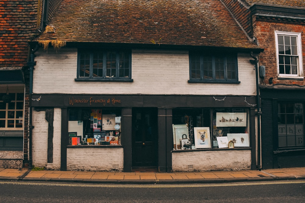 a white brick building with a store front