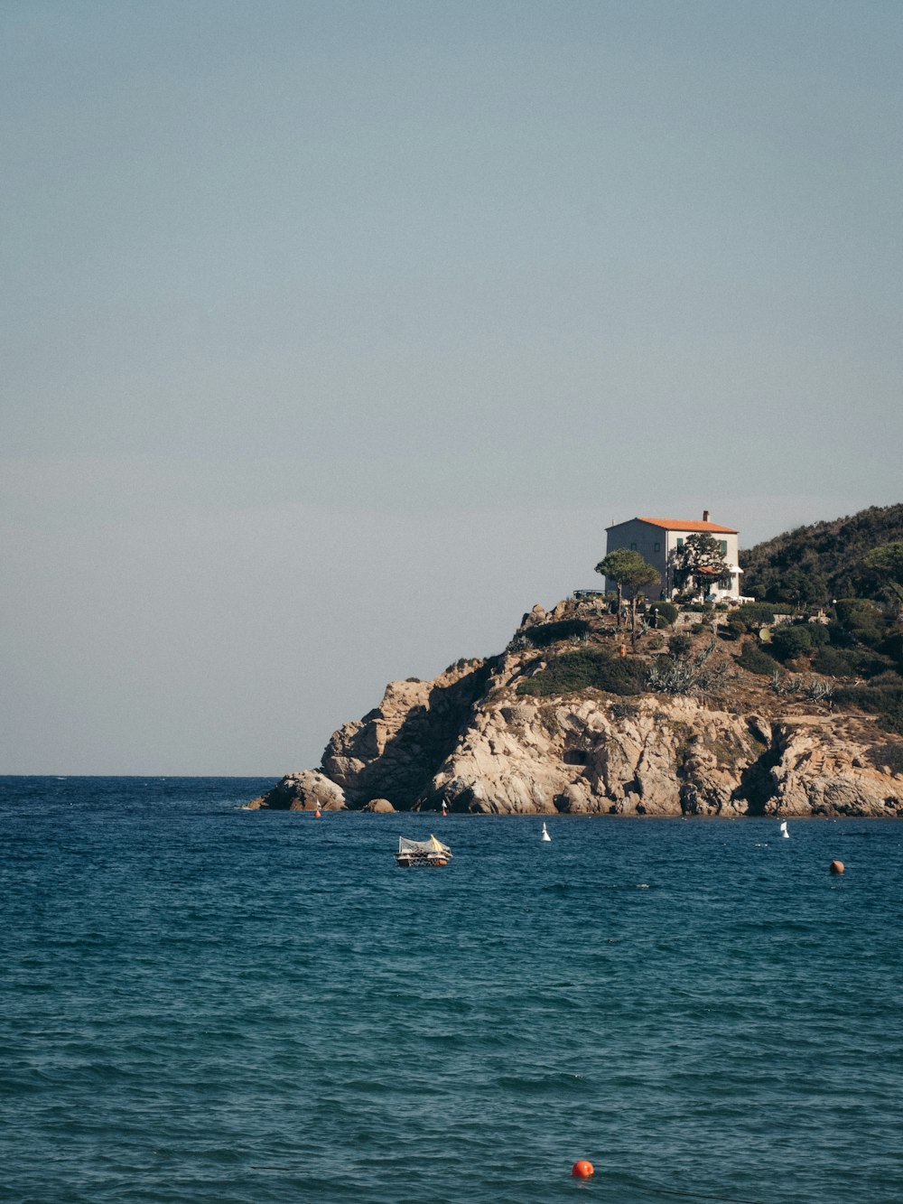 a house on a small island in the middle of the ocean