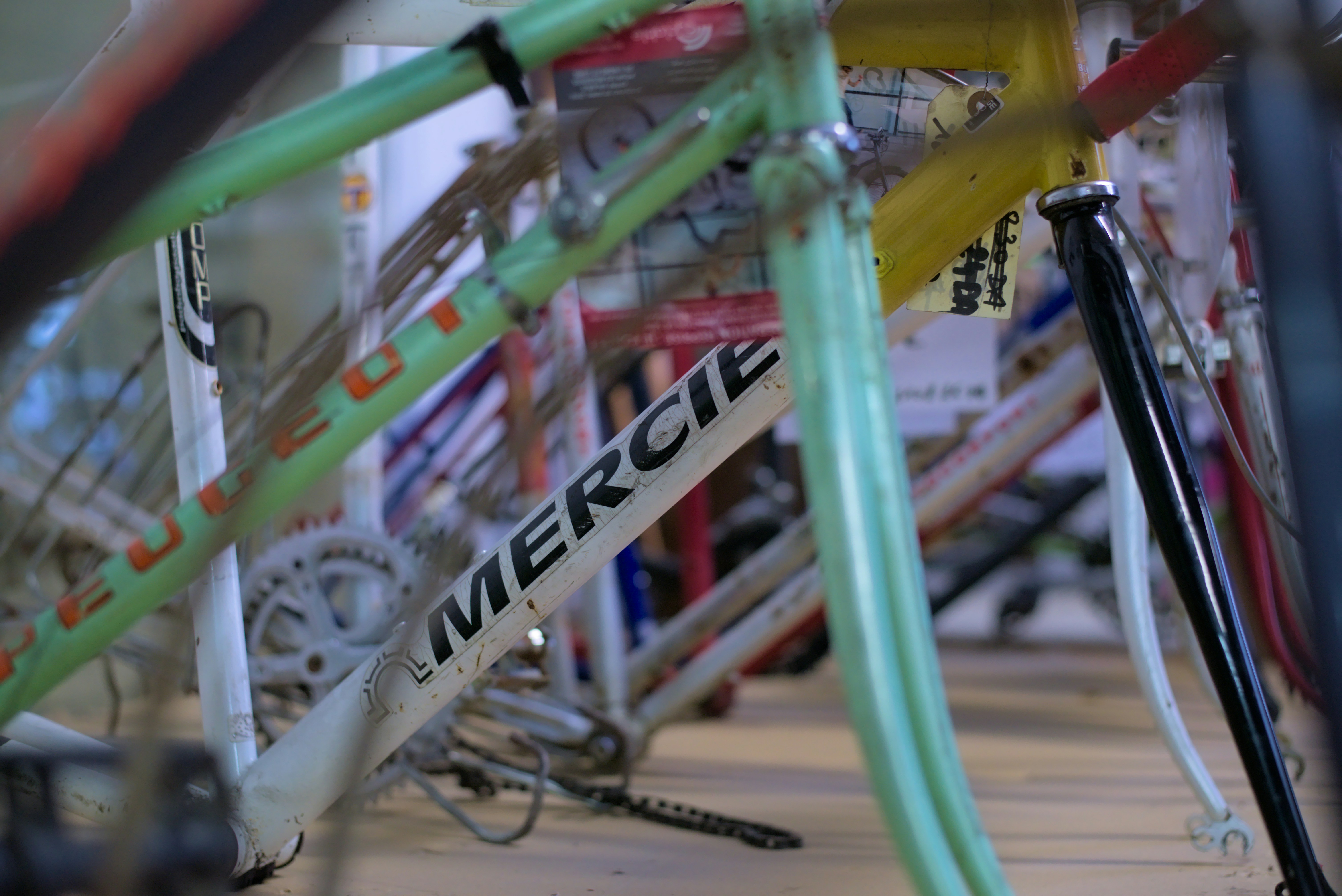 a close up of many different colored bikes