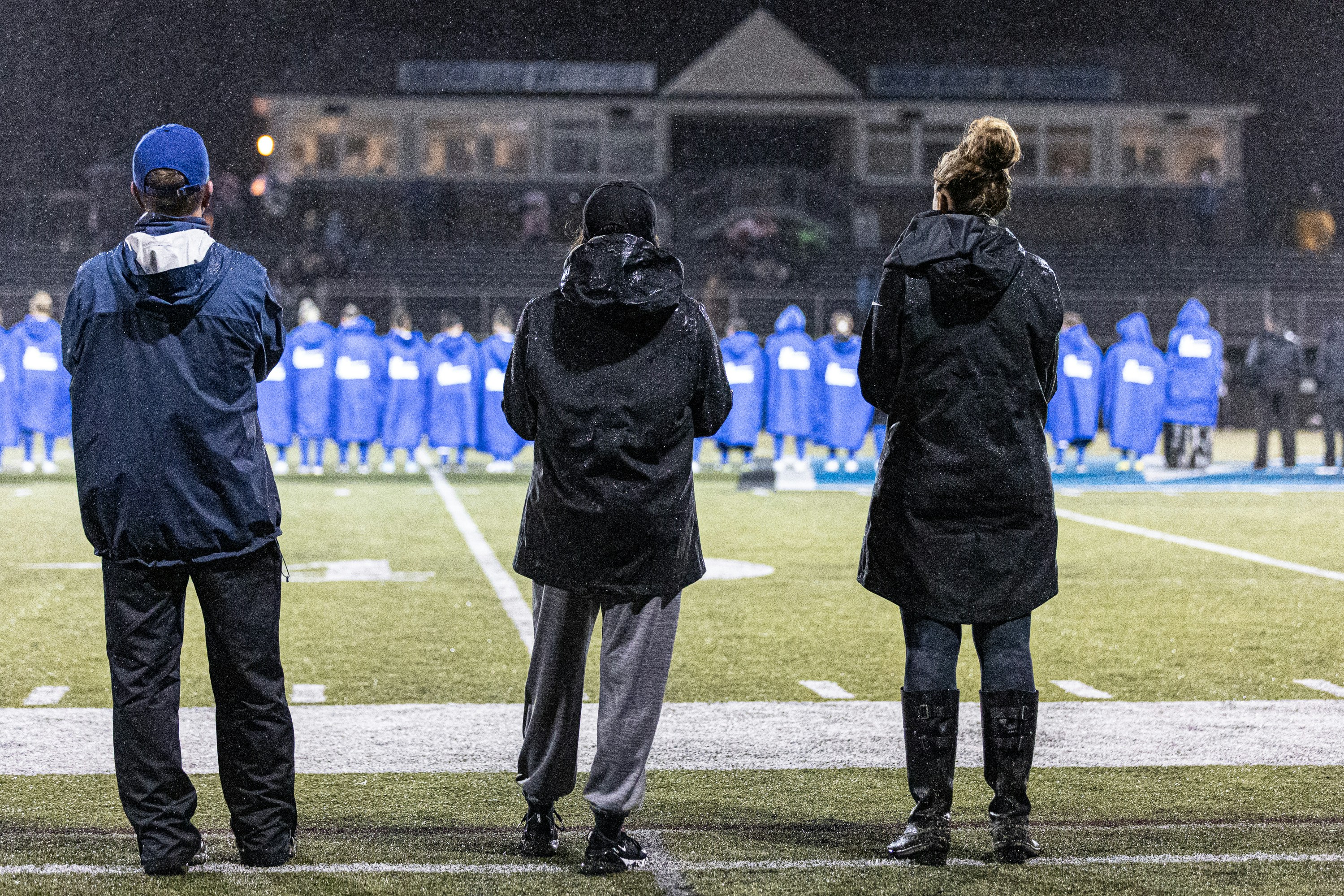 a group of people standing on top of a field