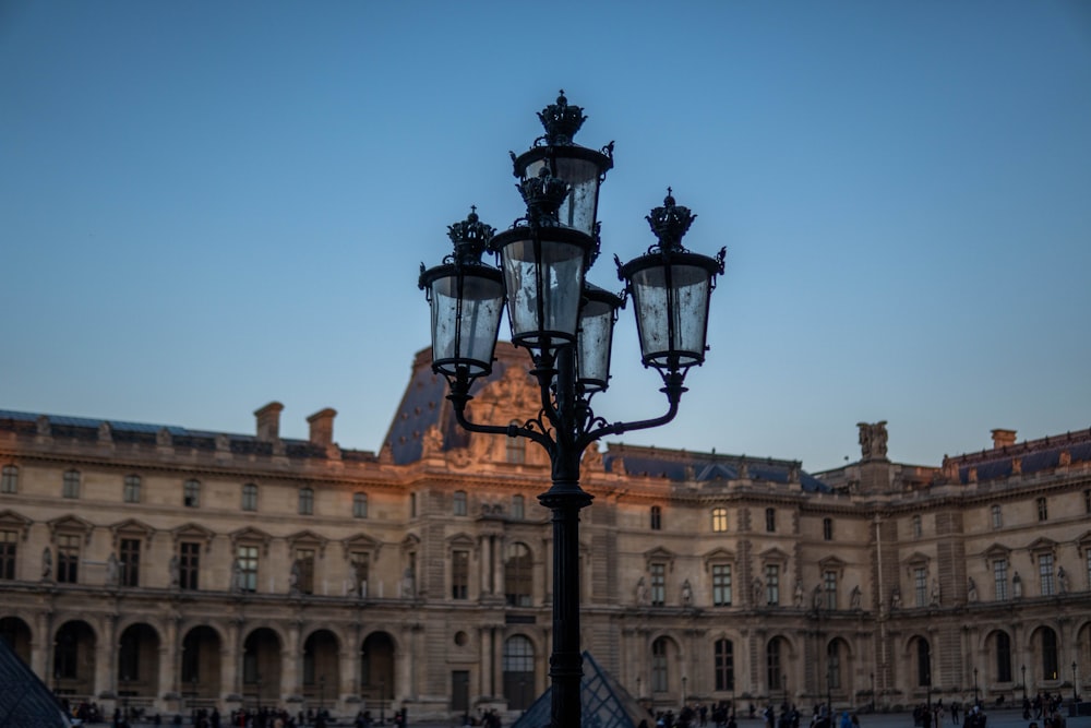 a street light in front of a large building