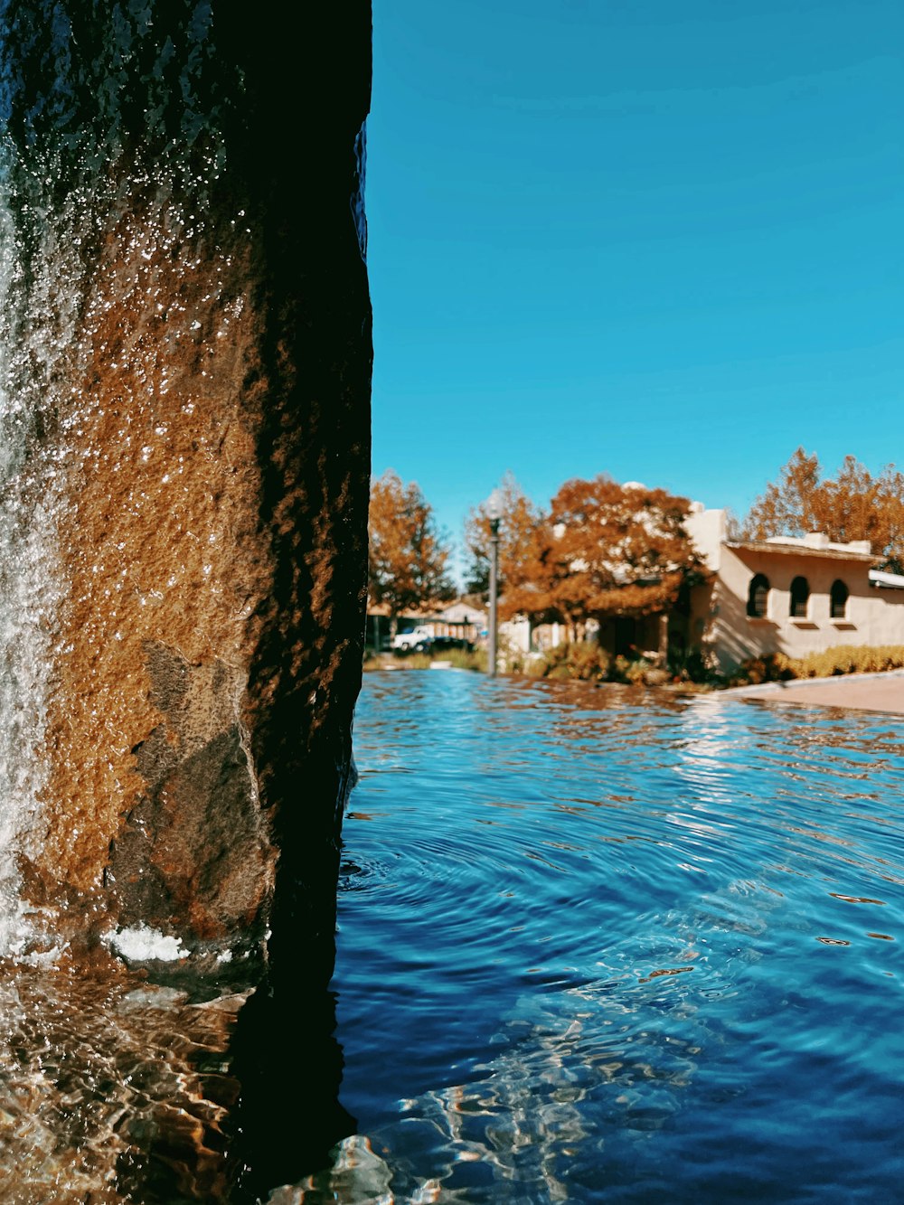 a view of a body of water with a house in the background