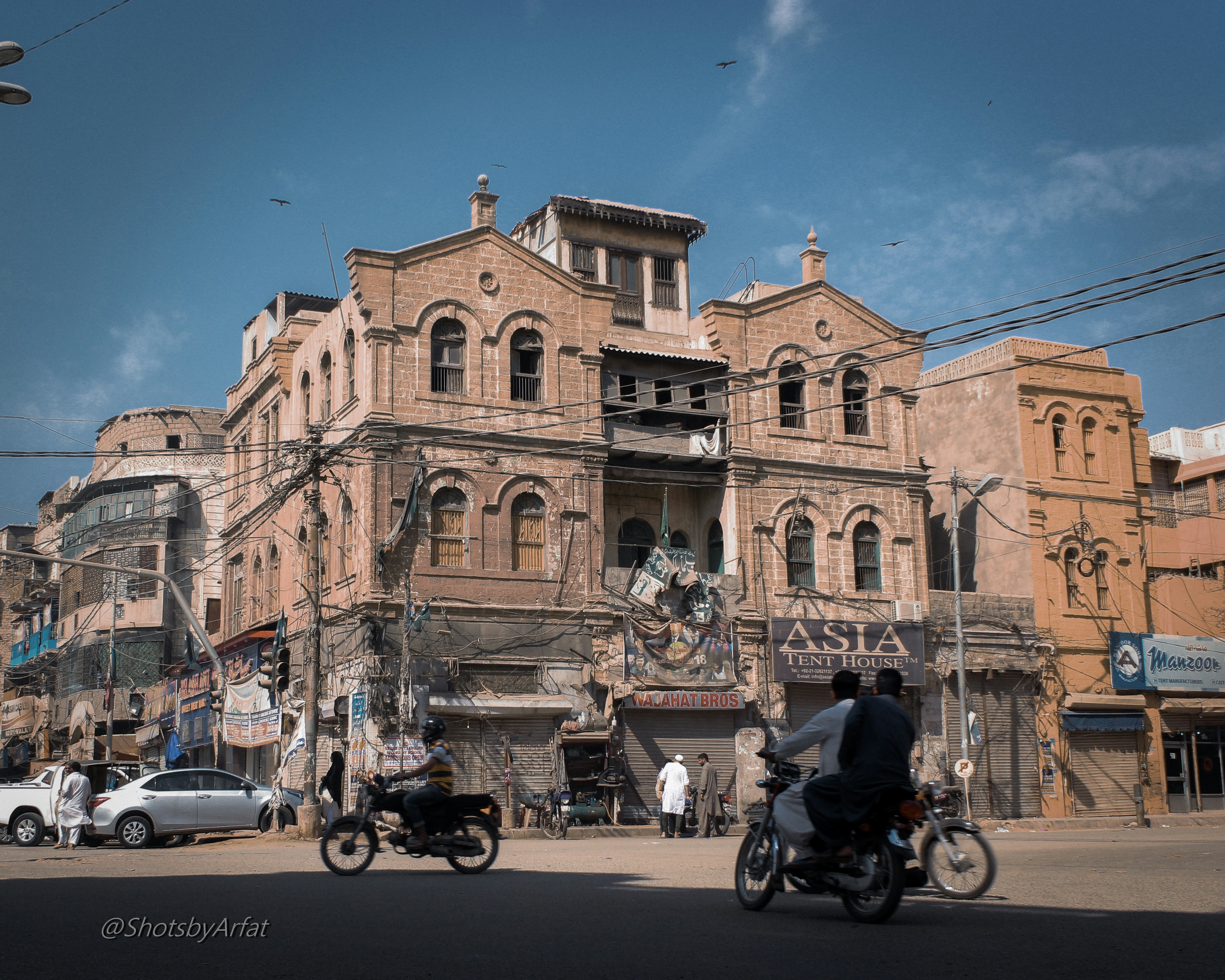 a group of people riding motorcycles down a street