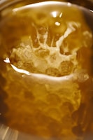 Mystical queen bee NFT surrounded by golden light and hexagons