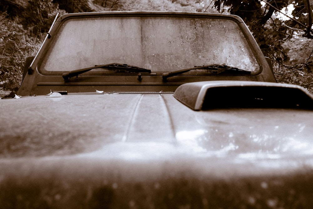 an old pick up truck parked in a wooded area