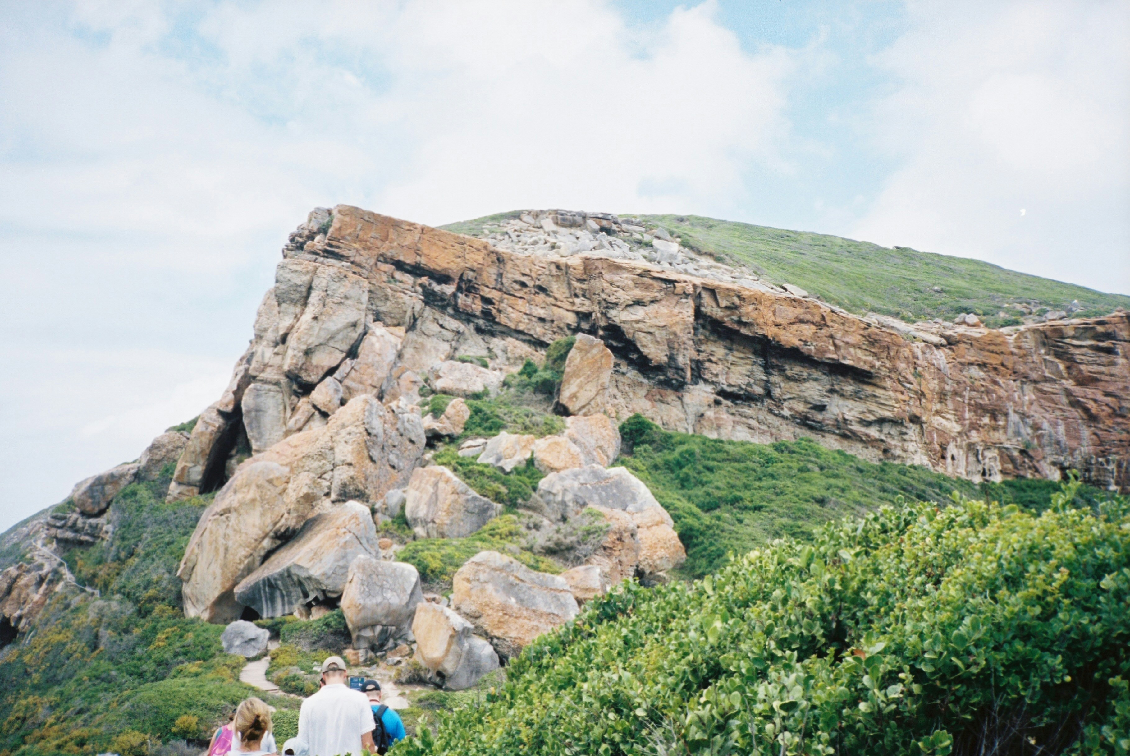 a group of people walking up a hill
