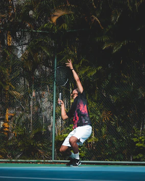 a man holding a tennis racquet on a tennis court