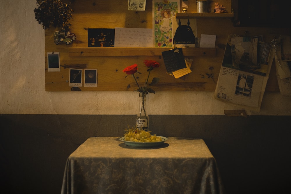 a table topped with a vase filled with flowers