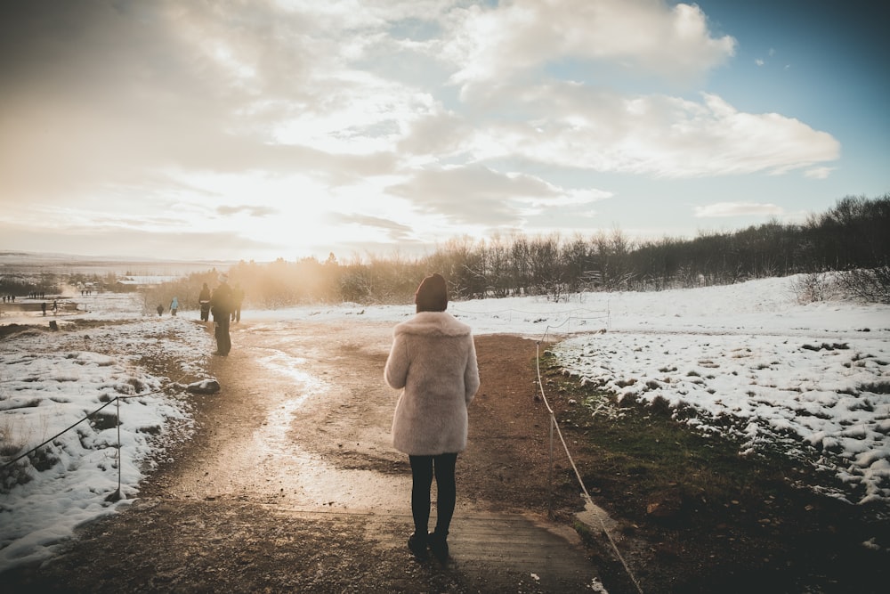 a person walking down a path in the snow