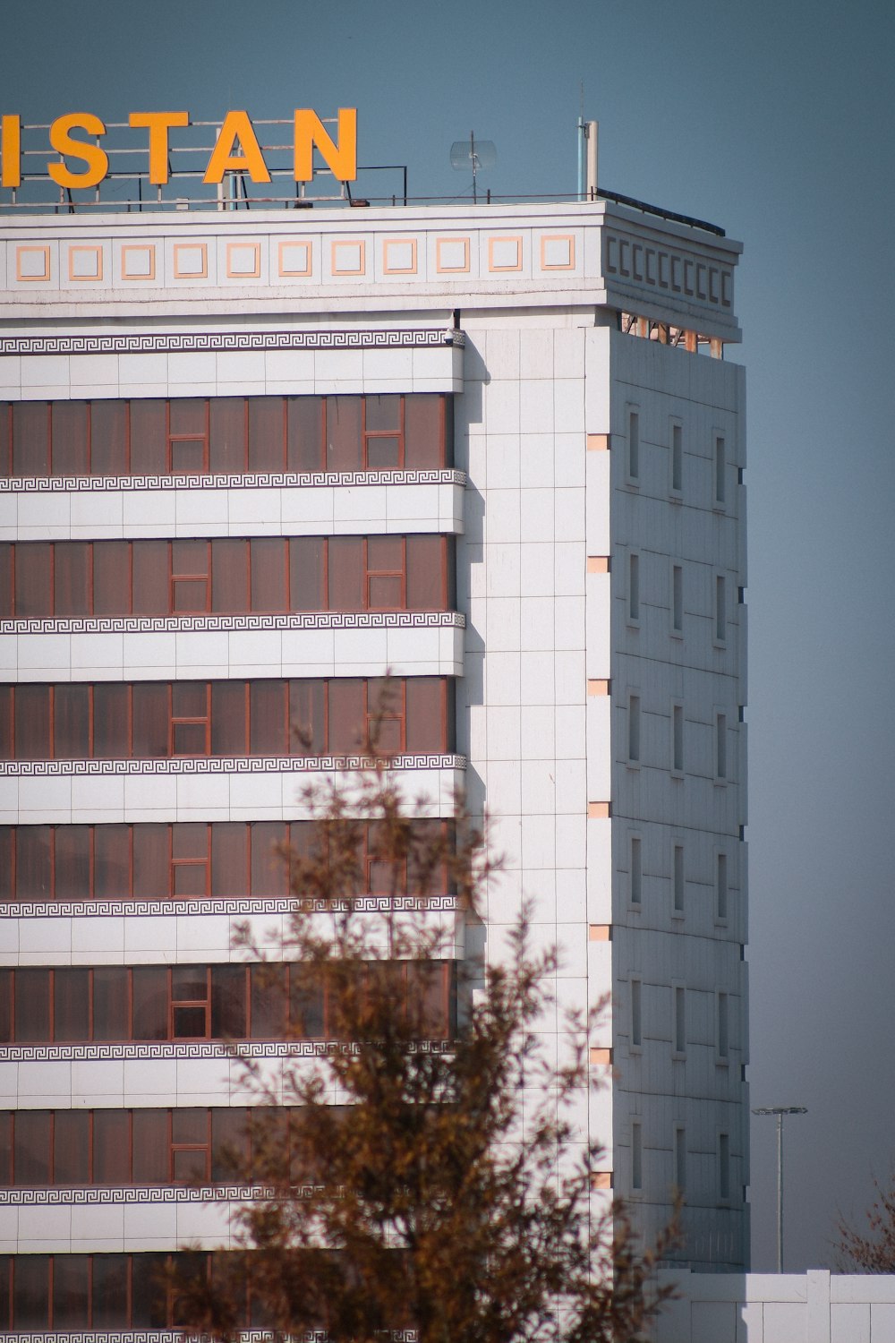 a tall building with a sign on top of it