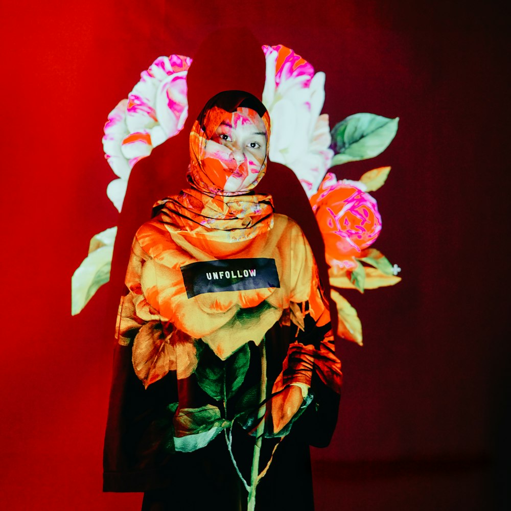 a woman with a painted face holding a flower