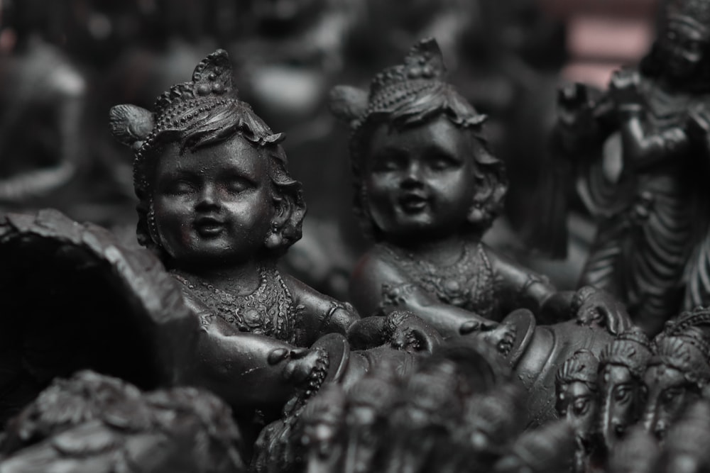 a black and white photo of a group of statues