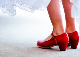 a close up of a person wearing red shoes