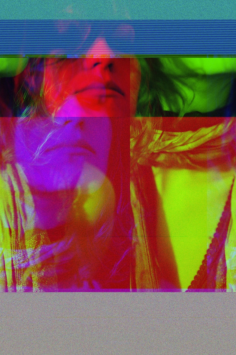 a woman with long hair wearing a yellow shirt