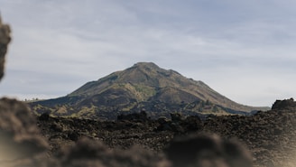 a mountain is seen through a hole in the ground
