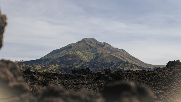 a mountain is seen through a hole in the ground
