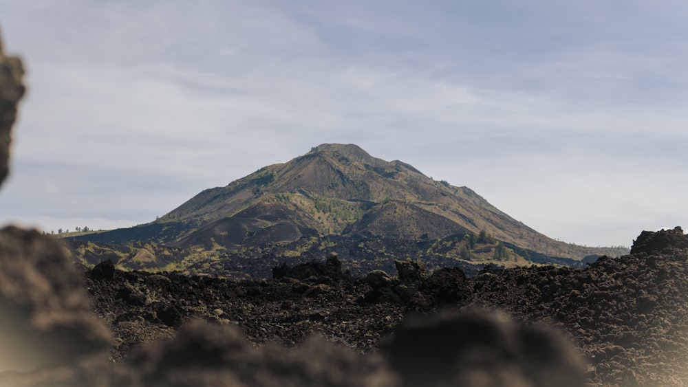 a mountain is seen through a hole in the ground