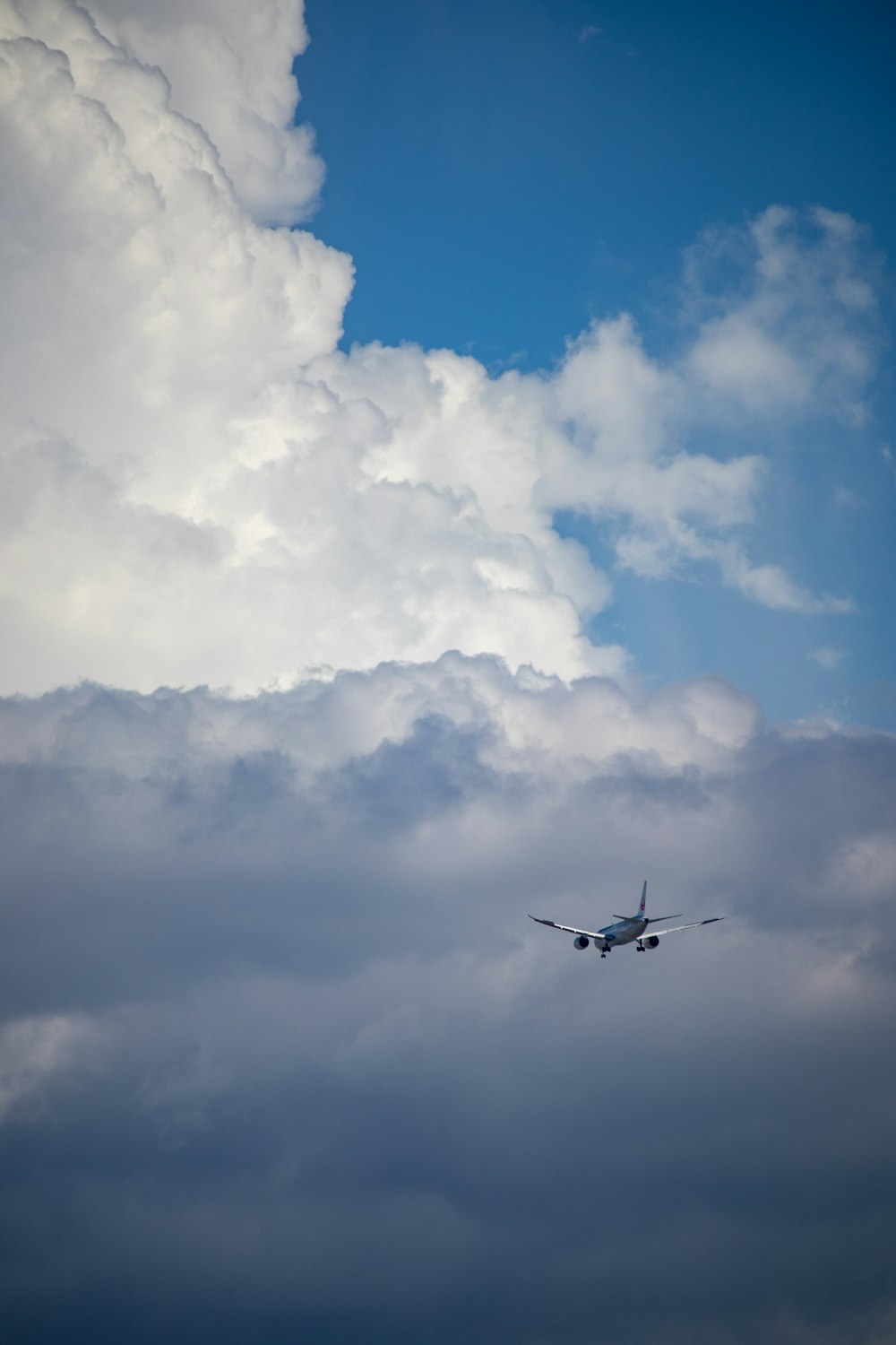 an airplane is flying through a cloudy sky