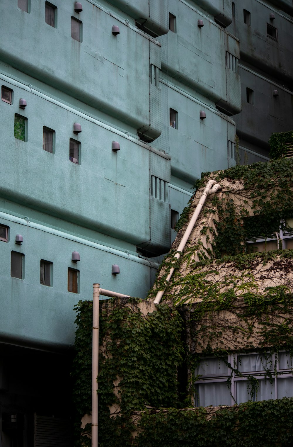 an old building with ivy growing on the side of it