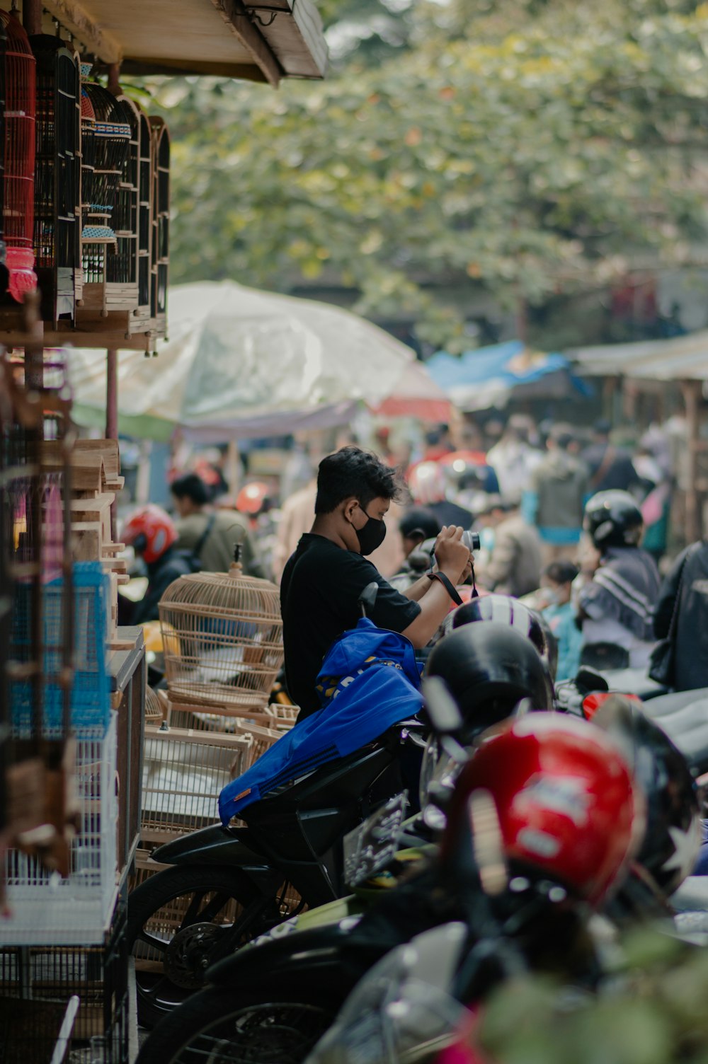 a man sitting on a motorcycle in front of a crowd of people