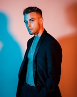 a man wearing a suit and a necklace
