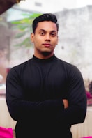 a man standing with his arms crossed in front of him